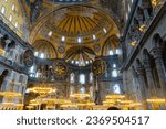 Small photo of ISTANBUL, TURKEY - Mai 19, 2023: tourists walking under chandelier in Aya Sophya mosque. Inside Hagya Sophya mosque in Istanbul. Window and wall of Aya Sophya