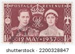 Small photo of UNITED KINGDOM - 1937 May 13: An one and half pence purple-brown postage stamp showing portraits of King George VI and Queen Elizabeth. Coronation of George VI and Elizabeth