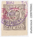 Small photo of COLOMBIA - 1902: an original 10 centavo black postage stamp showing Coat of Arms with Magenta Overprint
