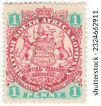 Small photo of RHODESIA - 1896: An 1 pence scarlet and emerald postage stamp depicting Arms of the British South Africa Company. The ends of ribbons containing motto cross the animals legs. Pen cancellation