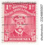 Small photo of RHODESIA - 1913: An 1 pence bright rose postage stamp depicting portrait of King George V in Royal Navy uniform. BSAC was founded with the support of the British Government
