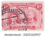 Small photo of RHODESIA - 1910: An 1 pence rose-carmine postage stamp depicting portrait of the Royal Couple, Queen Mary and King George V. BSAC was founded with the support of the British Government