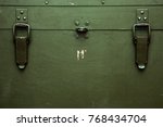A green military storage box for ammunition. Green box from the war with scratches and locks in front.