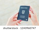 croatian passport in hand | Shutterstock . vector #1243960747