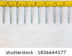 Small photo of Metal ruler and scows, centimeters and millimeters on the yellow ruler. Sizes.