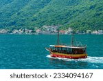bay of Kotor with cruise ship for sea trip, Montenegro, bright sunny day, mountains and small towns on the coast, summer travel concept