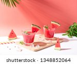 Fresh water melon juice and watermelon slice on red background. summer drink.