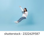 Happy asian teenage girl using tablet social media online floating in mid-air isolated on blue background. freedom fast internet technology concept.