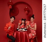 Small photo of Asian family holding angpao,red packet monetary gift in the meal on celebration chinese new year isolated on red backdrop. Chinese text means Have a wish Blessing 5, good luck and much happiness, rich