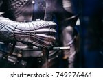 Close up of a Medieval steel armour with hand holding a giant sword