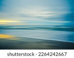 Sunset on the beach, abstract. Motion blur abstract seascape in light turquoise and yellow colors, copy space