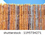 Small photo of The fence is made of uncouth logs.