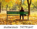 A woman on a bench in park