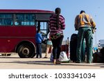 Small photo of People waiting with luggage to embark on a bus from Dakar to Ziguinchor in Senegal, Africa.