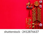 Small photo of Firecrackers for Chinese new year (word mean wealth, blessing) with gold ingots (word mean wealth), red envelope packet (word mean good luck and good fortune) and pendant dragon on red background.