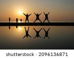 Small photo of Young people are cheerfully frisking in the sunset glow background at Chichibugahama, Kagawa pref.