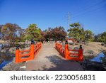 Small photo of Scenery of vermilion color bridges in the garden in autumn in the blue sky background at Fukui pref.