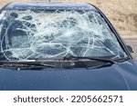 Damaged windscreen of the car during an accident