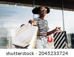 Portrait of beautiful stylish african american woman, after shopping near the store, shopping on black friday, black friday, clearance sale, shopping