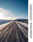 Small photo of The road to nowhere. Wildlife in the Finnmark region of northern Norway on the border with Finland. Rough, inhospitable nature in winter with sunrise and blue skies. Exploring the polar region.