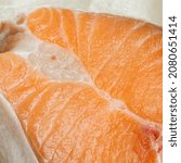 Small photo of Proper healthy nutrition. Raw red salmon fish slice close-up with texture. Product containing vitamin D, A, B, C, PP phosphorus, iodine, calcium, potassium, sodium, magnesium, zinc, fluorine, omega-3