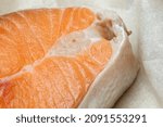 Small photo of Proper healthy nutrition. Raw red salmon fish slice close-up with texture. Product containing vitamin D, A, B, C, PP phosphorus, iodine, calcium, potassium, sodium, magnesium, zinc, fluorine, omega-3