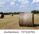 Round Hay Bales In Field With...