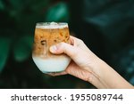 Hand Holding Ice Latte Coffee with Cream, Cold Summer Drink Background