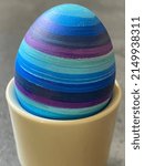 Small photo of blue striped easter egg in eggcup