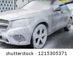 Car in foam. Car getting a wash with soap, car washing.