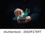 Small photo of Trader holding smartphone and touching to technical graph chart for analysis stock market data and speculator investment concept.