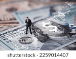 Businessman miniature figure standing on USD banknote with stock market chart graph for currency exchange of global trade forex and Fed increase interest rate to stop inflation concept.