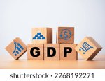 Small photo of GDP or Gross Domestic Product wording print screen on wooden cube block with icons include graph dollar exchange shopping trolley and gold bar for economic recession concept.