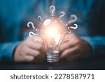Glowing lightbulb and question mark with copy space for creative thinking idea and problem solving concept.