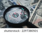 Stock market chart inside magnifier glass on Benjamin Franklin face of USD banknote for focus and analysis currency exchange and global trade forex concept.