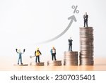 Small photo of Miniature different career include technician , Chief , Engineer, and Manager standing on various height coins stacking with up arrow and percentage , Inequality income and salary concept.