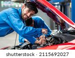 Happy smile Caucasian automobile mechanic man checking car damage broken part  condition, diagnostic and repairing vehicle at garage automotive, motor technician maintenance after service concept