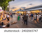 Small photo of Bangkok, Thailand - December 16, 2023: Evening time At Chatuchak Market, witness young performers and street musicians showcasing diverse talents through busking and live performances.