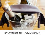 Prosecco bottles, over ice in an ice bucket