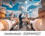 Male worker inspection at steel long pipes and pipe elbow in station oil factory during refinery valve of visual check record pipeline tank oil and gas industry