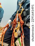 Small photo of Closeup male worker standing on tank male worker height roof tank knot carabiner rope access safety inspection.