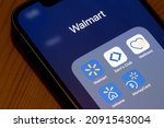 Small photo of Portland, OR, USA - Dec 15, 2021: Assorted Walmart Inc.'s mobile apps are seen on an iPhone, including Walmart Shopping and Grocery, Sam's Club, Walmart Wellness, InHome Delivery, and MoneyCard.