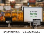 Small photo of Irvine, CA, USA - May 8, 2022: Closeup of the Amazon Fresh sign seen inside an Amazon Fresh grocery store in Irvine, California. Amazon Fresh is a subsidiary of the e-commerce company Amazon.com.