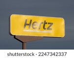Small photo of Burlingame, CA, USA - May 5, 2022: Hertz sign is seen outside one of its car rental offices near the San Francisco International Airport in Burlingame, California.
