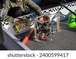 Small photo of Berkeley, CA, USA - Nov 20, 2023: A student fills up a robot's pneumatic reservoirs with an inflator during a practice at the VEX Worlds Championship qualifying One World Showcase Event at UC Berkeley