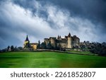 Small photo of Castle on a hill under a gloomy sky. Castle on hill. Medieval castle. Castle panorama