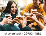 group of people cheering and drinking beer at bar pub table -Happy young friends enjoying happy hour at brewery restaurant-Youth culture-Life style food and beverage concept