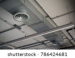 High resolution photo of circular air duct and Ventilation pipe of air conditioning system (HVAC) hanging from ceiling inside building. Danger and the cause of respiratory diseases in office staff.