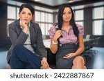 Small photo of Two young women express boredom and fatigue at the office, capturing the monotony and disengagement of daily workplace routine