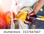 Young man, fill diesel tank of car after finish refill diesel oil in gas station